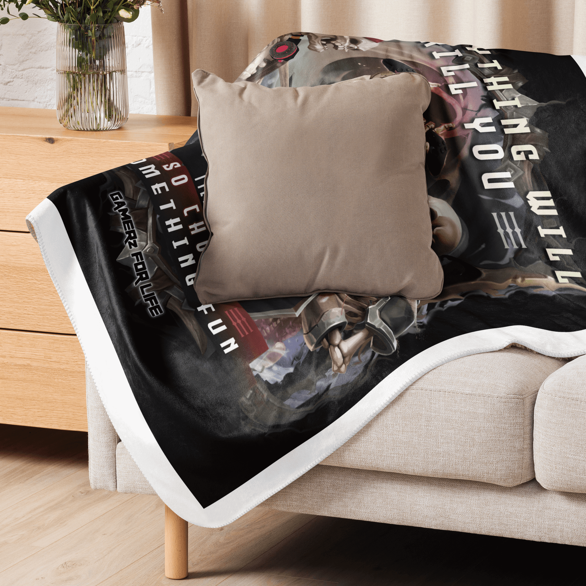 Cozy "Everything Will Kill You" sherpa blanket draped over a couch with a cushion, perfect for home decor and warmth.